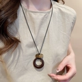 Close-up of resin round pendant necklace on model with vintage bohemian style - 17# Necklace-Coffee-Round