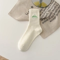 Creamy white mid-calf ribbed cotton socks featuring green mountain dreamer embroidery - One Size / Cream