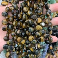 Close-up of polished tiger eye stone beads for DIY jewelry with golden cat-eye effect - 10mmx12mm / Natural Tiger Eye Stone