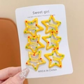 Set of six yellow star-shaped metal hair clips with colorful dots on a card display - Star Shaped Clips / Set of 6 / Polka Dot Yellow