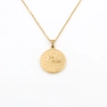 Detail of 18k gold Virgo zodiac pendant showing embossed symbol and knurled edges - Virgo
