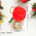 Macro detail of Christmas letter G resin keychain with red pompom and festive inclusions - Letter G