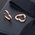 Close-up of rose gold heart hoop earrings with micro-set white cubic zirconia stones - Heart Shape / Rose Gold