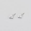 Detailed view of silver four-leaf flower earrings with sparkling cubic zirconia stones - Silver White Zirconia