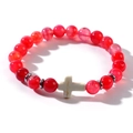 Close-up of red beaded bracelet featuring a white cross stone bead and metal spacers - Red (Agate Color)