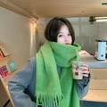 Soft mohair-style green scarf with tassel fringe worn in a bright cafe setting - Grass Green