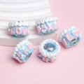 Macro shot of blue and white resin crown-shaped DIY beads with LOVE engraving - Trans Blue Bead + White Edge Blue Cream + LOVE