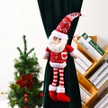 Detail of knitted Santa Claus curtain buckle with striped long legs on green velvet - Santa Claus