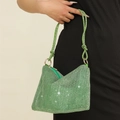 Close-up of luxury green rhinestone evening bag with knotted handle and gold zipper detail - Green