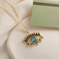 Détail macro du collier œil du démon doré avec incrustation de zircon bleu et pierres - Œil Bleu