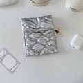 Close-up of a silver quilted sanitary pouch with heart tag and white button closure - Diamond Grid Silver