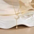 Macro view of gold plated crescent moon pendant with micro-pave zircons and water drop charm - Elegant Moon Drop Zirconia (XL0320)