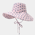 Pink sun hat with blue heart patterns featuring a large brim and matching chin strap bow - One Size / Pink