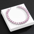 Detailed view of silver tennis chain with heart-shaped pink zircon stones on display stand - 10 inch (25cm) / Silver Anklet (Pink Zircon)