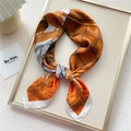 Elegant orange and brown geometric silk square scarf tied in a stylish bowtie knot - Orange Knit Print