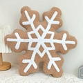 Detail of snowflake plush pillow featuring soft brown sherpa fleece and white embroidery - Snowflake Shape
