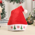 Detail of red velvet Christmas hat featuring white plush cuff with festive tree embroidery - Christmas Tree Snowflake