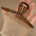 Large tortoiseshell acetate claw clip with gold metal spring for thick hair styling - Green Wilderness