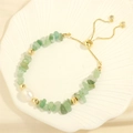 Detail of handmade elastic bracelet with green gemstones, white pearl and gold slider - Green Aventurine