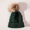 Detailed cable knit texture of dark green winter hat with brown faux fur pom-pom - One Size / Dark Green