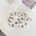 Detailed macro view of white quilted cartoon dog coin pouch with a metal key ring attachment - Cartoon Dog