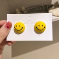 Close-up of yellow round acrylic smiley face earrings on a white branded display card - 16# Smiley Face Pattern Studs