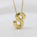 Macro shot of 18K gold plated puffy balloon initial S pendant on thin necklace chain - Letter S (Necklace)