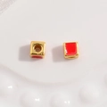 Macro detail of red enamel heart pattern on square S925 sterling silver golden beads - Gold and Red Square Style
