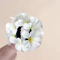 Handheld white frangipani flower elastic hair scrunchie with yellow center accents - White Hibiscus Scrunchie