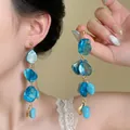 Long blue tassel shell earrings with golden links worn by a model for summer vacations - Blue Tassel Shell (1# Silver Earring Post)
