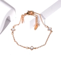 Detail of rose gold bracelet featuring zircon-encrusted charms and delicate linked chain - Rhombus Zirconia Gold