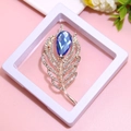 Detail of leaf-shaped gold brooch with blue crystal teardrop and inlaid small diamonds - XZ073-Blue Feather-Boxed
