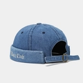 Detailed view of blue denim docker hat with white Basic Club embroidery and metal buckle - Basic Club Embroidery Style / Dark Blue