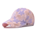 Detail of pink baseball cap featuring delicate purple floral lace overlay and curved brim - Adjustable / Purple