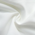 Detailed macro view of pure white textile fabric with a premium diagonal twill weave pattern - S / White