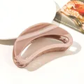 Detail of a large glossy nude brown hair claw clip with a hollow crescent design - 12cm Moon - Shiny Lotus Pink