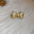 Detailed view of golden matte brushed hoop earrings on white soft textured background - Gold Matte Brushed Ring