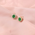 Macro detail of a gold clover earring with green oval zircon and white crystal border - SE817 Green Oval Zirconia