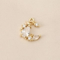 Macro shot of gold crescent moon pendant with micro-pave zircons on beige fabric - PJ0295-Gold (Crescent Moon & Star)