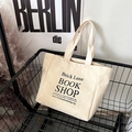 Beige canvas tote bag with Brick Lane Bookshop print in a stylish metal cart - Large Letter Beige (Large)