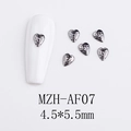 Macro detail of gothic black heart alloy nail charms with textured hammered finish - Hammered Texture Heart (AF07)