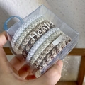 Close-up of durable woven hair ties with leopard print and solid colors in a clear box - White Coffee Mixed Set