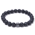 Macro shot of 8mm black lava rock beads showing detailed porous texture on elastic bracelet - Lava Rock Bracelet