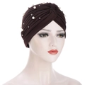 Detail of dark brown turban hat with white pearls and stylish pleated fabric texture - Coffee