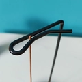 Minimalist black metal incense holder with paperclip design on a sleek blue background - Incense Rack Only (No Base)