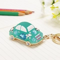 Green rhinestone car keychain with gold metal hardware and sparkling gemstones - Blue Jelly Beetle