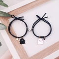 Detailed view of magnetic ghost heart bracelets for couples in a wooden frame - Black (Pair)