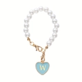 Detail of pearl cup accessory with light blue heart charm featuring a golden letter W - Letter W