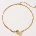 Detail of double-layer gold necklace featuring snake chain and polished ball pendant - 18K Gold / Gold