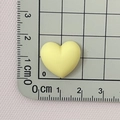 Close-up of a matte yellow resin heart bead on a measuring mat showing 1.5 cm size - Yellow